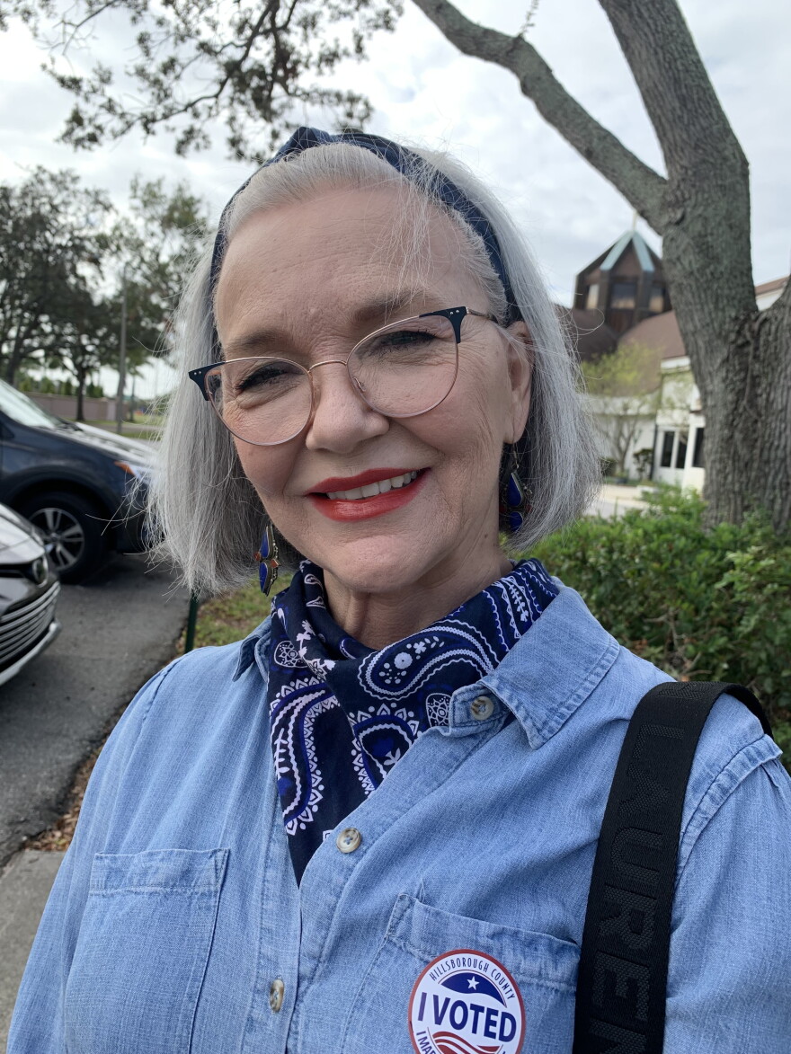 Woman wearing a denim shirt and scarf around her neck