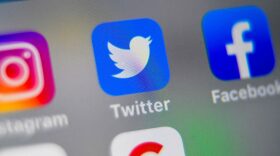 A picture taken shows logos of US social networking websites Instagram, Twitter and Facebook, displayed on smart-phone screen.