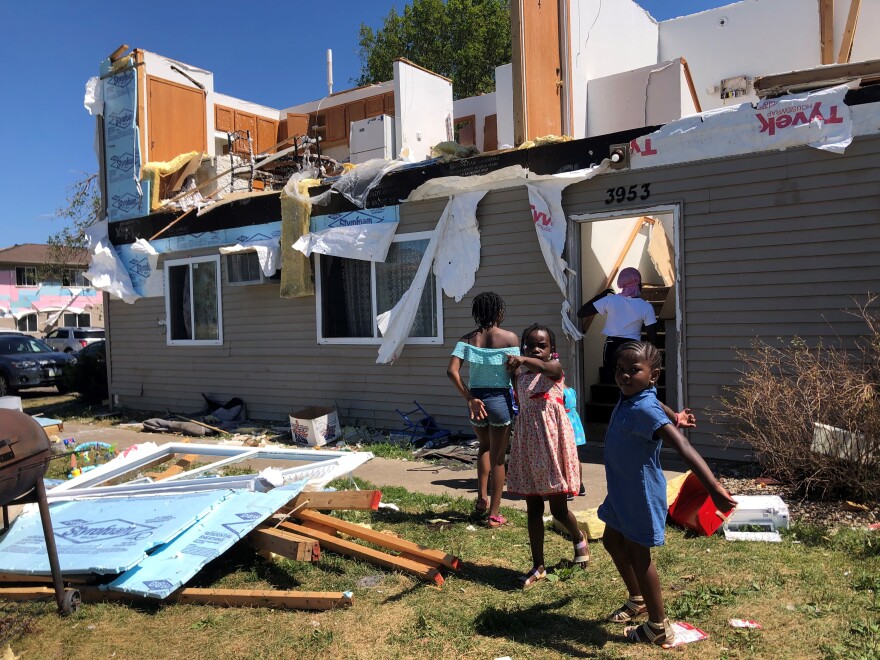 Children play outside a unit at the Westdale Court Apartments in southwest Cedar Rapids. Some homes there were left unlivable after the powerful derecho storm brought hurricane-force winds to the city.