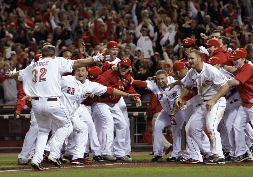 Reds' Jay Bruce (32) is greeted at home plate after hitting a home run off Houston Astros relief pitcher Tim Bydak in the ninth inning of a baseball game, Tuesday, Sept. 28, 2010, in Cincinnati, where the home team clinched the NL Central with a 3-2 win. 
