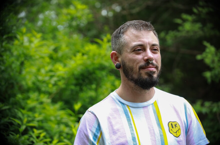 Alexx Abreu stands on the lawn of the house he's been staying at in Overland Park for the last six months. He planned to move back to the Kansas City metro, but when a slew of anti-trans bills were introduced or signed into law in Missouri and Kansas, Abreu packed up to move out of state.