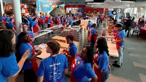 Military families line up for pantry supplies at a Blue Star Family event at the Virginia Air and Space Museum in Hampton.