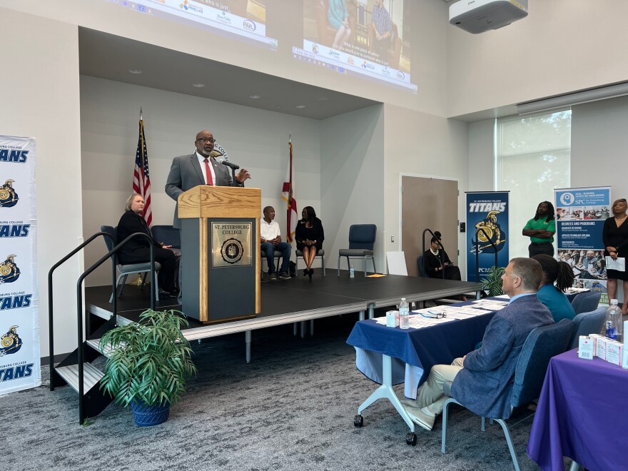 St. Petersburg Mayor Ken Welch stands at a podium and addresses a crowd at a job fair.