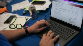Samuel Camacho, a health insurance navigator with the Universal Health Care Action Network of Ohio, assists people in enrolling for or renewing Medicaid.