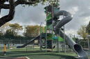 Image of an enclosed gray tube slide at a playground