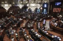 Illinois lawmakers listen to debate on the House floor during a session at the Illinois State Capitol.