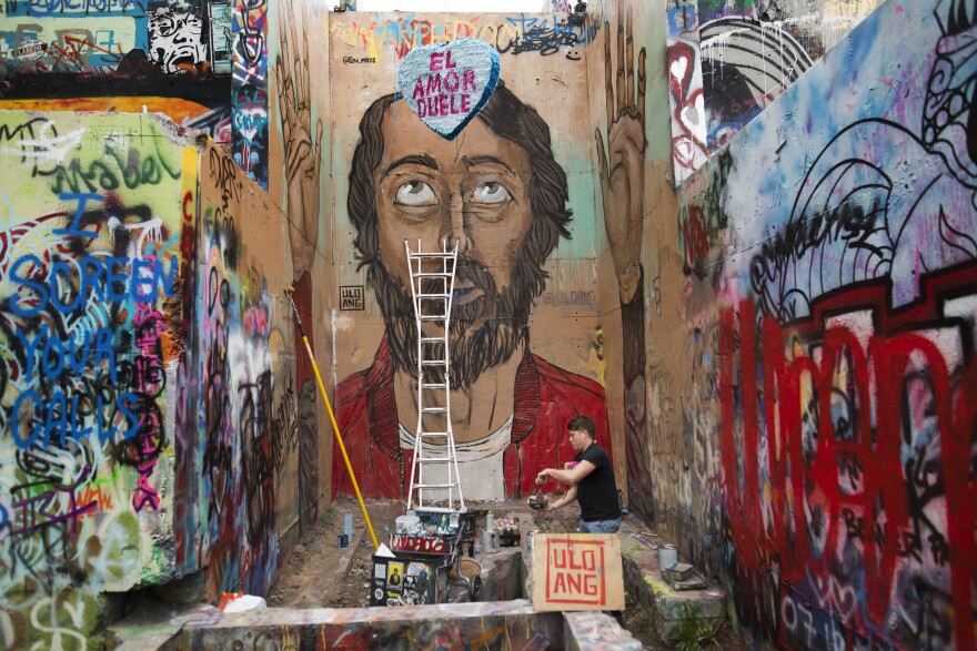 This picture shows a mural of a man at graffiti park. 