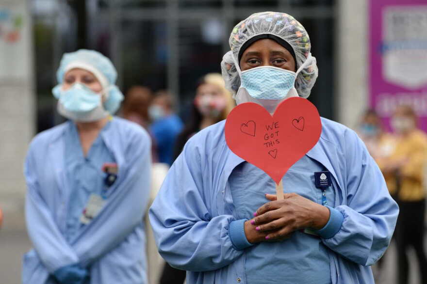Pamelia Bogle, an anesthesia technician at Hartford Hospital, holds a reassuring heart sign at a 2020 celebration for National Nurses Week at Hartford Hospital.
