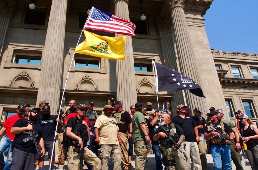 Gun rights activists, including members of the anti-government group The Three Percenters, stand on the steps of the Idaho State Capitol during a gun rights rally in September 2018. Three Percenters have been part of an effort by “no compromise” gun rights activists to make it harder to prosecute those who claim self-defense in shootings under proposed "stand your ground" bills. 