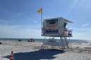 Beach with lifeguard seat with Sand Key Park sign 