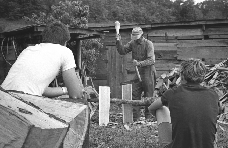 Fiddle player Bill Lamb makes shingles as students watch.