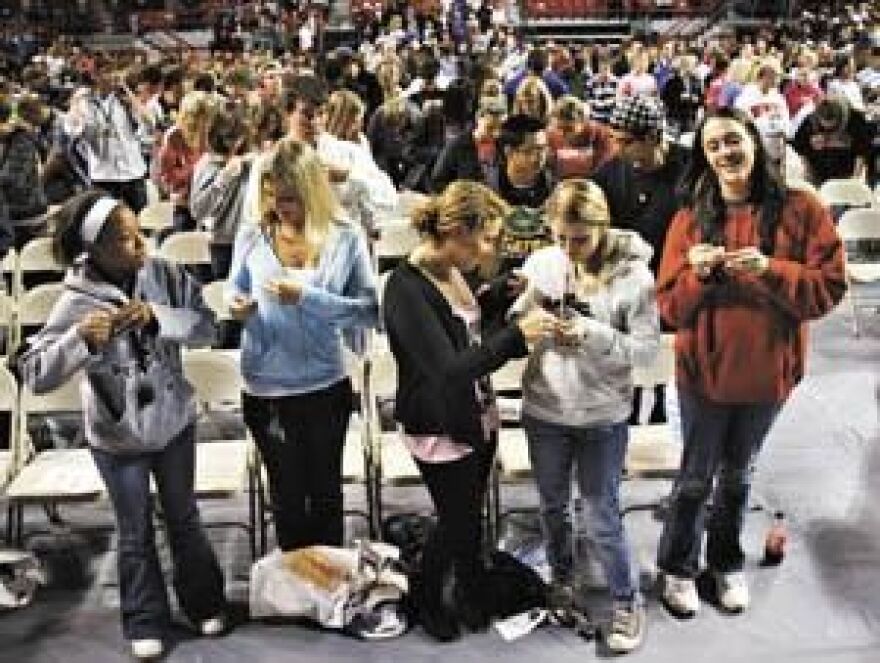 Members of Western Kentucky University's class of 2015 attach their class pins Tuesday during the WKU Freshman Assembly at E.A. Diddle Arena.
