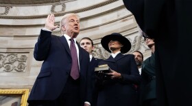 Donald Trump is sworn in as the 47th president of the United States by Chief Justice John Roberts as Melania Trump holds the Bible during the 60th Presidential Inauguration in the Rotunda of the U.S. Capitol in Washington, Monday, Jan. 20, 2025.