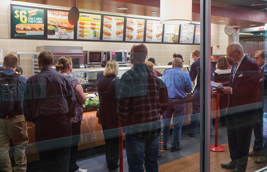 Diners wait in line at a Subway sandwich shop on September 15, 2015 in Chicago, Ill. Subway will serve antibiotic-free turkey and chicken by the end of 2016, but it may take nine years for its suppliers of beef and pork to go antibiotic-free as well.