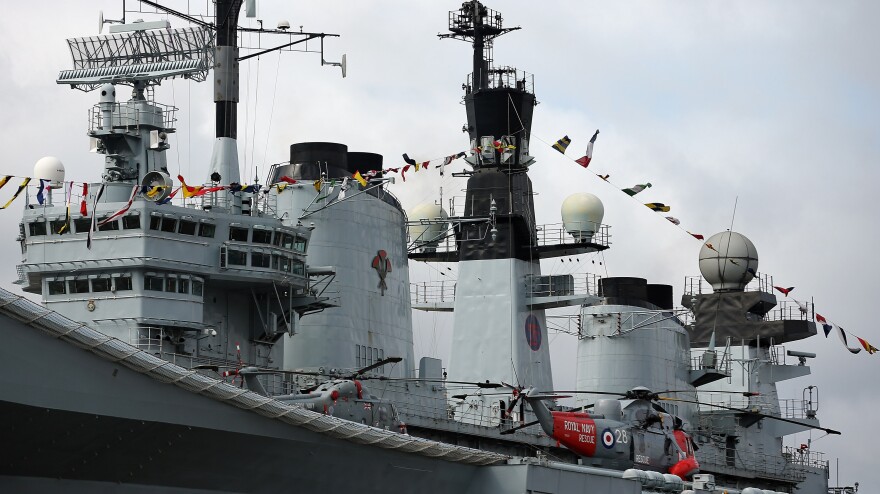 A Sea King helicopter rests on the flight deck of the HMS Illustrious in London.