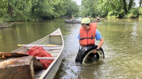 Pictured here - a volunteer helps with river cleanups that have helped remove an estimated 20,000 pounds of trash from Ohio waterways this year.