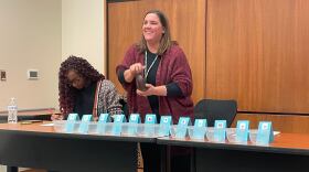 Christa Miller, Lancaster County’s election director, shakes a bottle filled with red, numbered marbles to determine the winner of tied races.