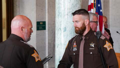 ACSD Cpl. Ben Fries accepting an award during a ceremony in 2025. He is currently the subject of a termination request by Sheriff Troy Hershberger for comments that appear to be making light of police shootings.