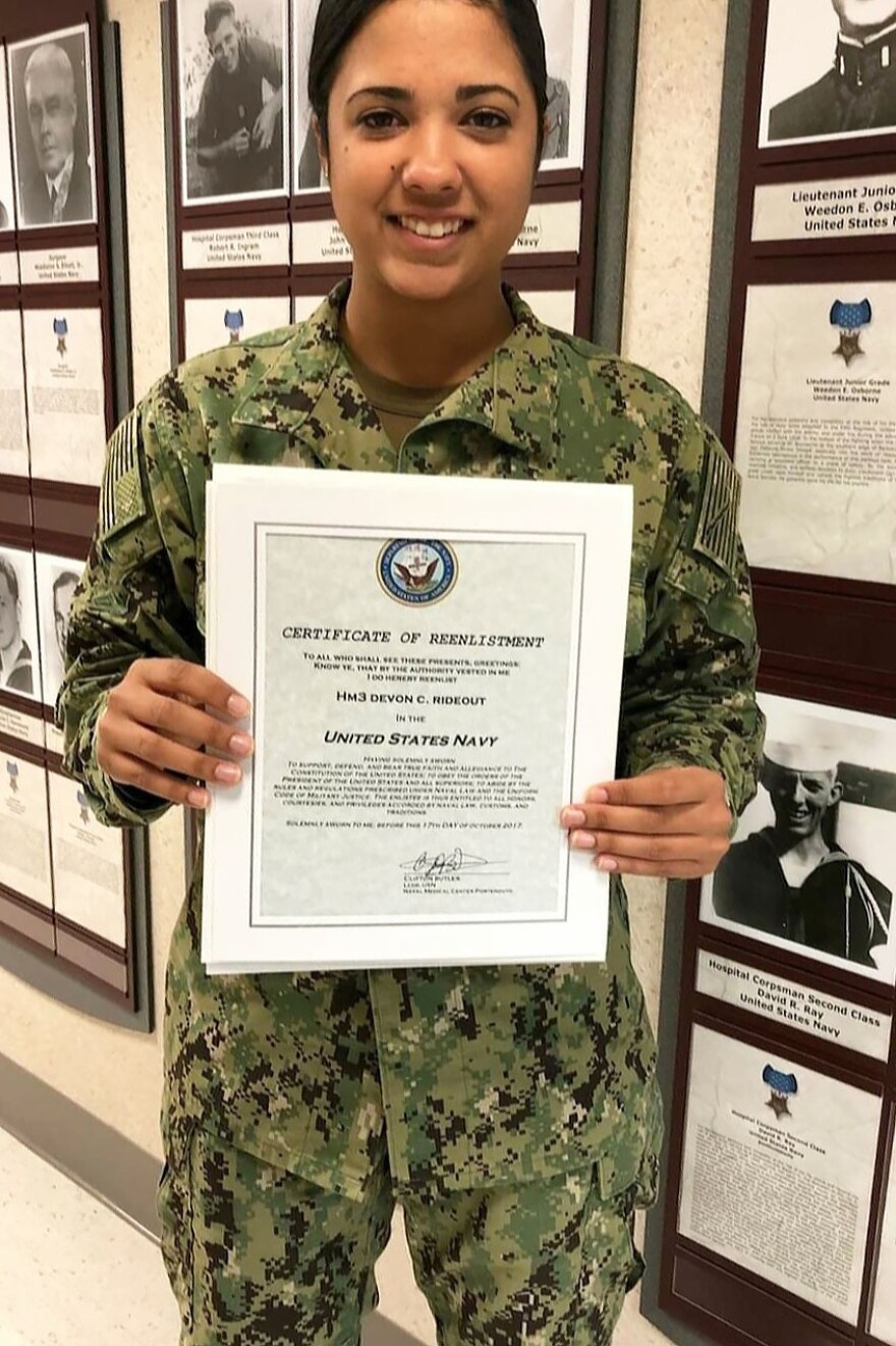 Devon Rideout holds her Navy reenlistment certificate in 2017. Her mother says Devon planned to earn a degree in occupational therapy and wanted to work with veterans.