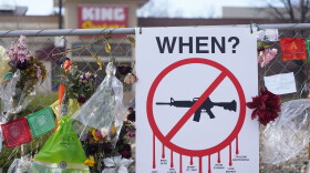 FILE - Tributes hang on the temporary fence surrounding the parking lot in front of a King Soopers grocery store in which 10 people died in a late March 2021 mass shooting, April 9, 2021, in Boulder, Colo. The son of one of 10 people killed at the Colorado supermarket in 2021 filed a lawsuit Tuesday, March 14, 2023, against gun maker Sturm, Ruger & Co. over how it marketed the firearm used in the massacre — following a litigation road map set by families of Sandy Hook Elementary School shooting victims. (AP Photo/David Zalubowski, File)