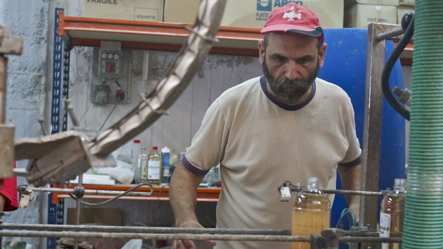 Makis Anagnostou, a worker and union leader, bottles lavender-scented fabric softener at VIO.ME, a former tile materials factory that went bust and has been revived by its staff as a collective making environmentally-friendly detergent.