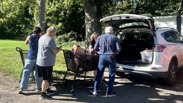 Volunteers unload groceries outside the Eastern Area Community Ministries in Louisville at the start of the city-wide food drive.
