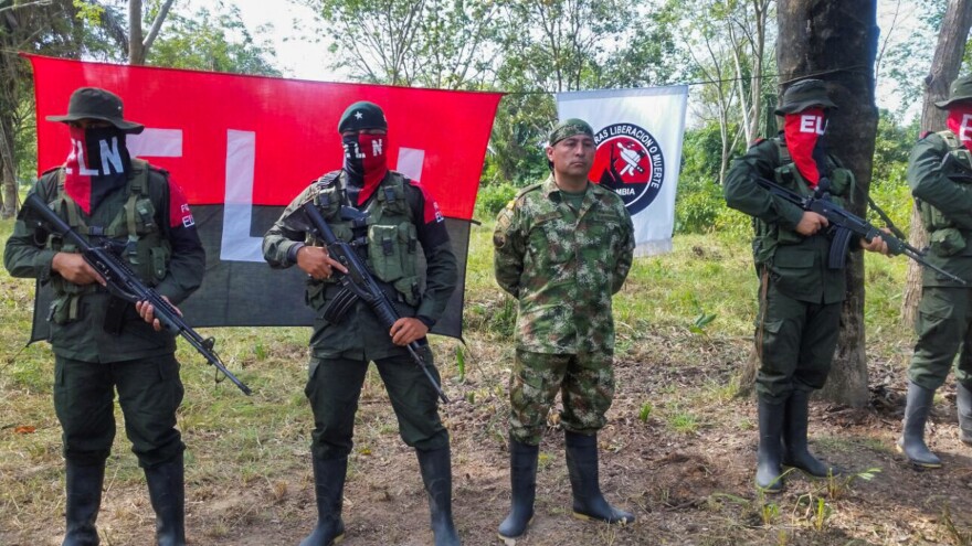 Colombian Soldier Fredy Moreno (center) who was captured by rebels of the National Liberation Army, is seen next to ELN members, before his release in Arauca, Colombia, on Feb. 6 2017.