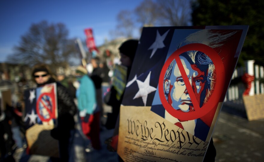 Anti-Donald Trump protesters rally outside the Pennsylvania Capitol Building before electors arrive to cast their votes on Monday in Harrisburg.