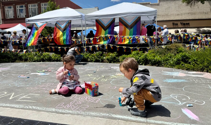 Two 3-year-old children play and draw in the chalk zone at the Walla Walla Pride Festival on Saturday, June 6, 2026.