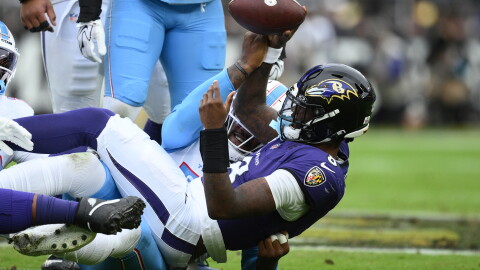 Baltimore Ravens quarterback Lamar Jackson (8) is sacked by Tennessee Titans defensive end Jacob Martin, left, during the first half of an NFL football game in Baltimore, Sunday, Oct. 4, 2026. (AP Photo/Nick Wass)