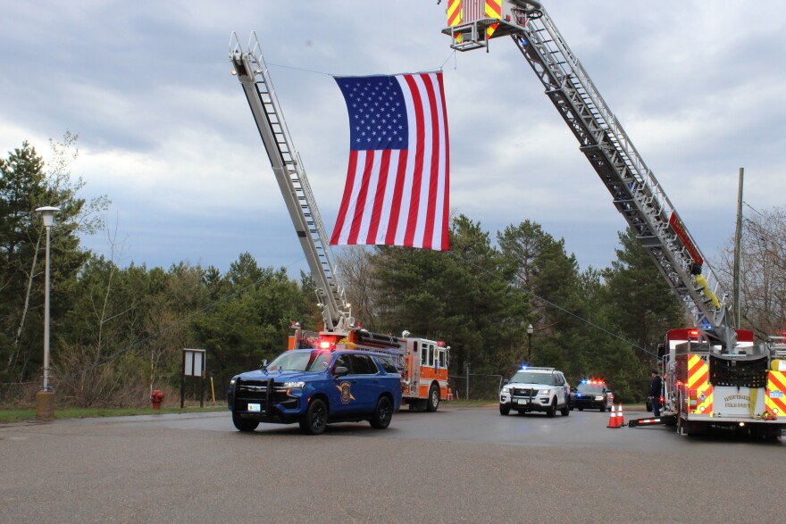 Law enforcement motorcade with flag