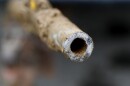 File-In this July 20, 2018 file photo, a lead pipe is shown after being replaced by a copper water supply line to a home in Flint, Mich.