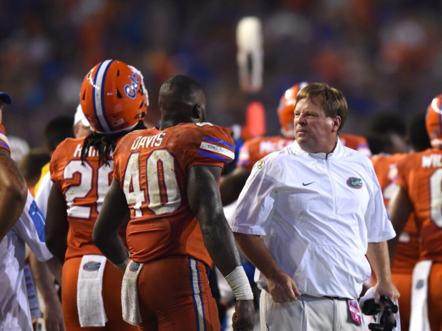 Florida coach Jim McElwain talks sternly to linebacker Jarrad Davis (40). McElwain was openly displeased about some of his player's behavior during the game. Florida committed 12 penalties, costing them 105-yards.