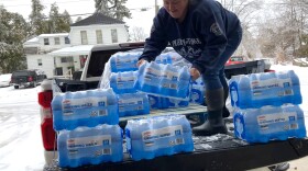 Shelbie Mosley, a volunteer firefighter with the Cheboygan Fire Department, unloads bottled water at a temporary warming shelter on April 2, 2025 at the city's fire hall.