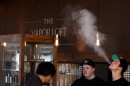 People using e-cigarettes and exhaling vapor