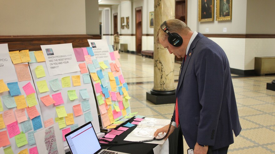 Rep. Bubba Carpenter, a Republican who represents Alcorn and Tishomingo Counties, flips through a binder of survey responses while at the listening station set up by the Gulf States Newsroom at the Mississippi State Capitol in Jackson, Mississippi, on Thursday, March 12, 2026. Carpenter said people with lived experience should “be part of the legislative process.”