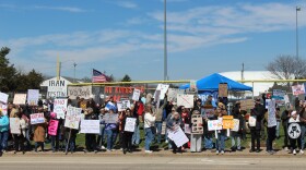 Along War Memorial Drive near Peoria Stadium demonstrators hold signs and protest the Trump administration. 