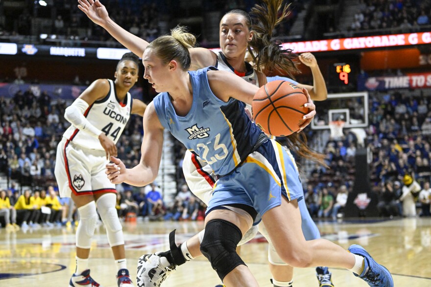 Marquette Golden Eagles guard Jordan King (23) was held to five points while UConn Huskies guard Nika Muhl (10) had 10 assists and 11 points during the UConn Women's Big East Tournament 81-52 win over Marquette