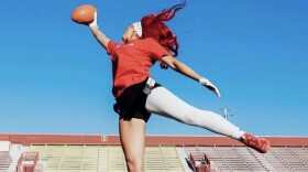 Joslyn Cetina jumping to catch a football.