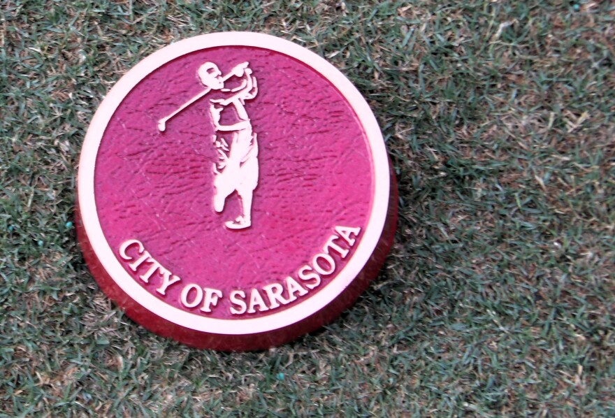 City of Sarasota medallion on a golf course