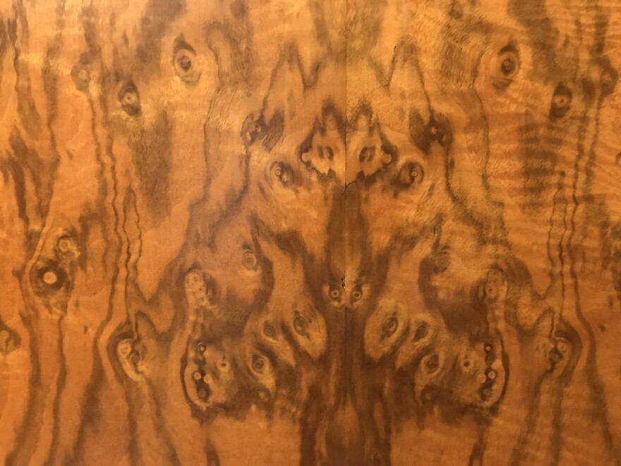 The walls of the Monkey Room on the first floor of the North Dakota Capitol reveal animal faces, such as this wolf with its paws outstretched. The room was paneled in rare California walnut in bookmatching style.