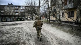 A Ukraine army soldier walks in the town of Schastia, near the eastern Ukraine city of Lugansk a day after Russia recognised east Ukraine's separatist republics and ordered the Russian army to send troops there as "peacekeepers."