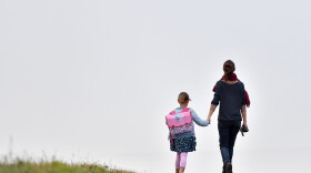 A girls walks to her primary school with her mother on the first day of the new school year in Vertou, western France, on Sept. 4, 2017. (Loic Venance/AFP Via Getty Images)