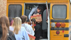 Forest City classmates hand Jacob Conlogue, a junior, boxes of food to be delivered.