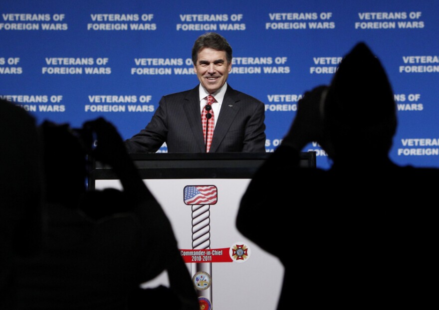 Republican presidential candidate Rick Perry is photographed by attendees as he addresses the VFW convention on Monday.