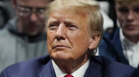 FILE - Former President Donald J. Trump watches the NCAA Wrestling Championships, Saturday, March 18, 2023, in Tulsa, Okla. Trump’s calls for protests ahead of his anticipated indictment in New York have generated mostly muted reactions from supporters, with even some of his most ardent loyalists dismissing the idea as a waste of time or a law enforcement trap. (AP Photo/Sue Ogrocki, File)