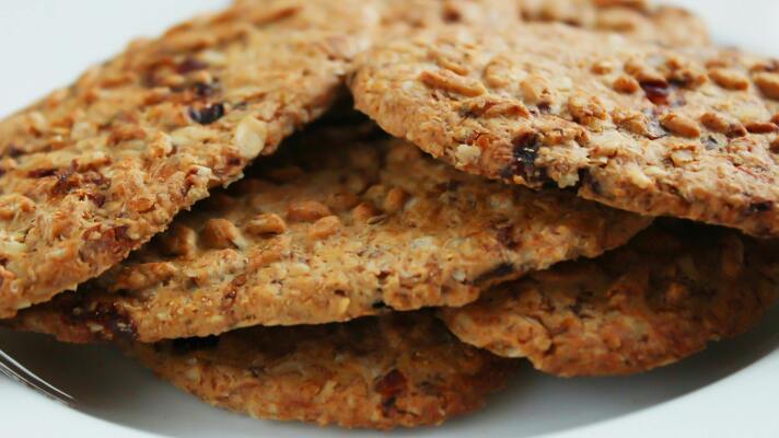 Brown round cookies served on a white ceramic plate.