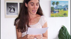 In her Havana apartment, Yoani Sanchez reads the acceptance speech she was unable to give in Madrid on Wednesday. She won Spain's Ortega y Gasset prize for digital journalism in recognition of her blog.
