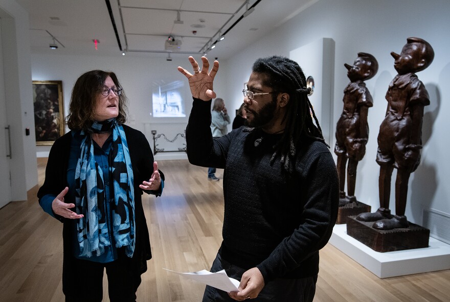 Susan Earle, Curator of European and American Art, discusses a painting with author and poet Anthony Boynton II in the newly redesigned galleries at the Spencer Museum of Art.