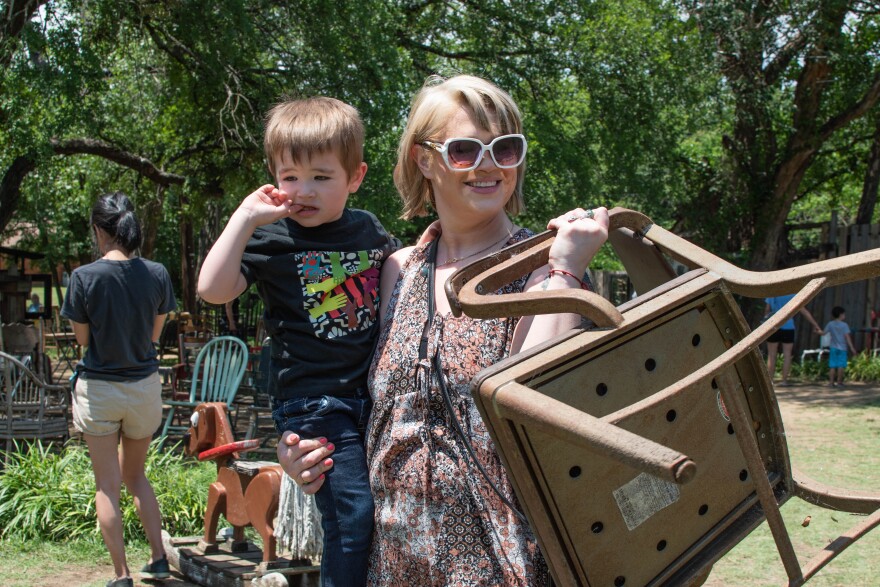 Amy Copeland carries a chair away from the Chairy Orchard on June 8th 2023.